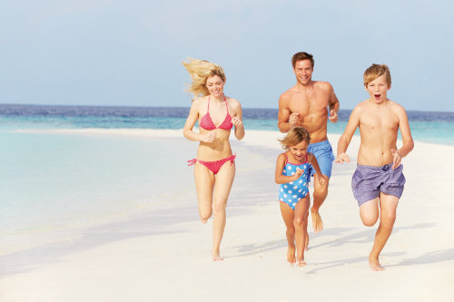 Family Having Fun On Beach Holiday